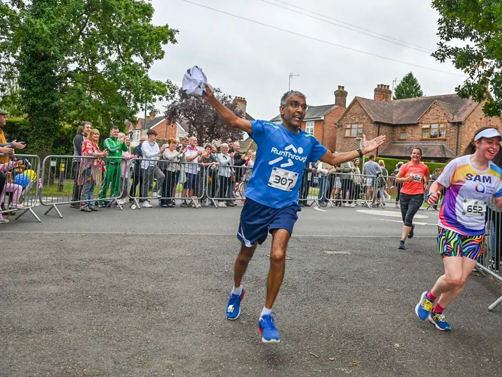 A RunThrough finisher celebrating at the line